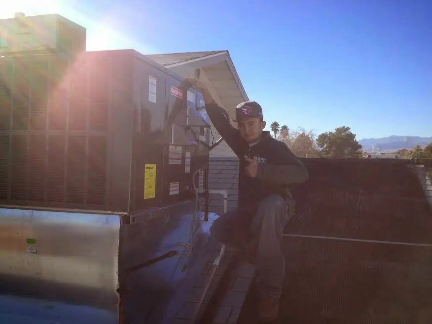 HVAC technician performing Air Duct Cleaning on a rooftop unit in Mount Joy